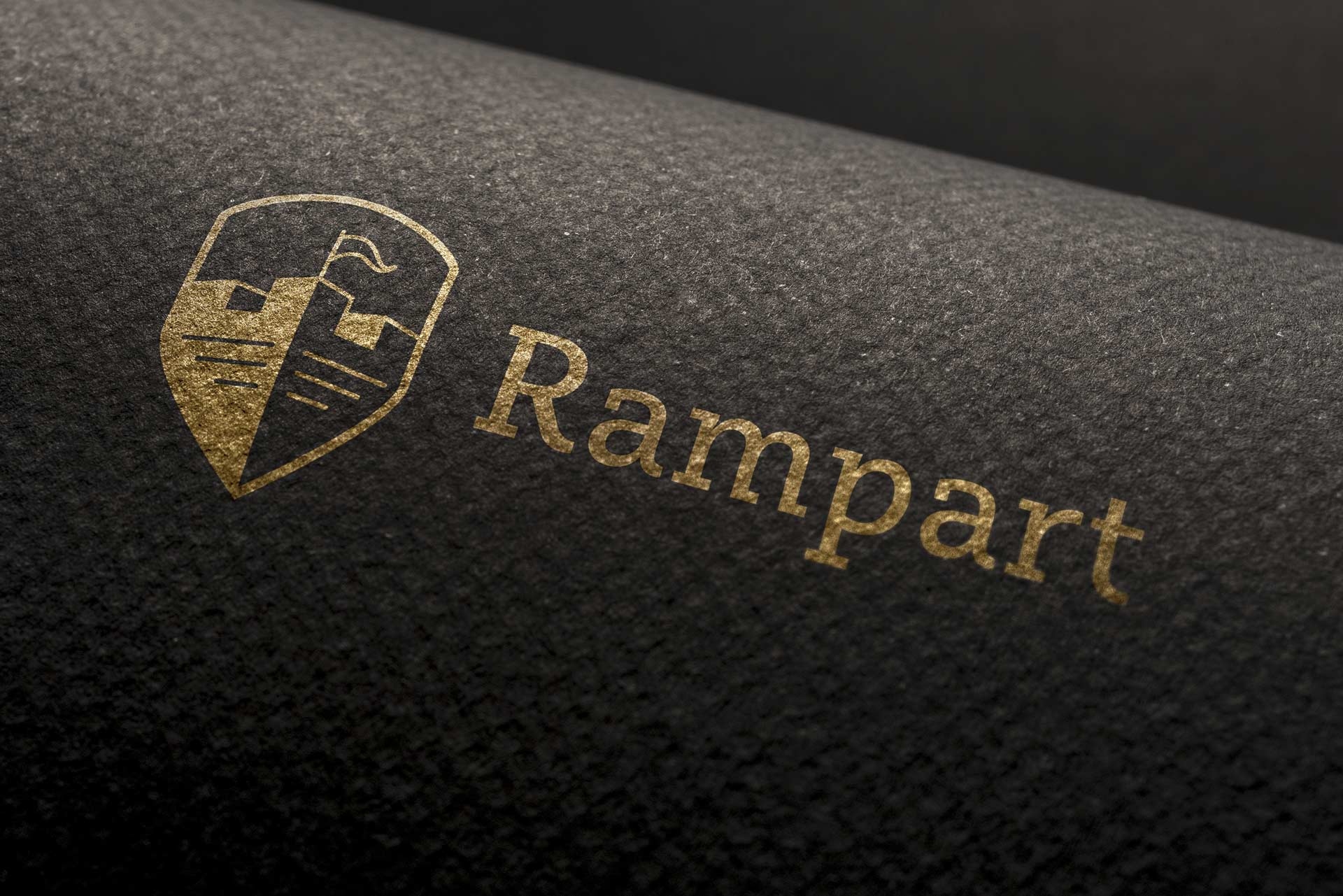 Dizajn logotipa i aplikacija na tekstilu za konsultantsku agenciju Rampart - zlatotiska